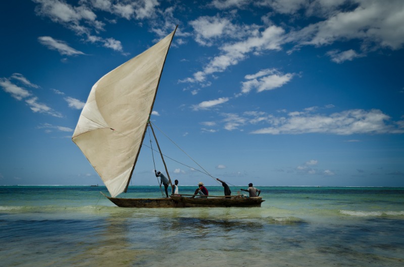 Tanzania Vacation Packages at the beach in Zanzibar city watching dhow